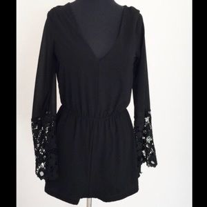 V-neck black romper w lace sleeves that bell out